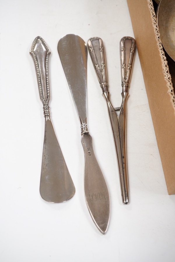 A small group of assorted silver and white metal items including a cased matched pair of Victorian silver pepperettes, an Edwardian silver five bar toastrack, a pair of late Victorian silver salts by William Hutton & Son